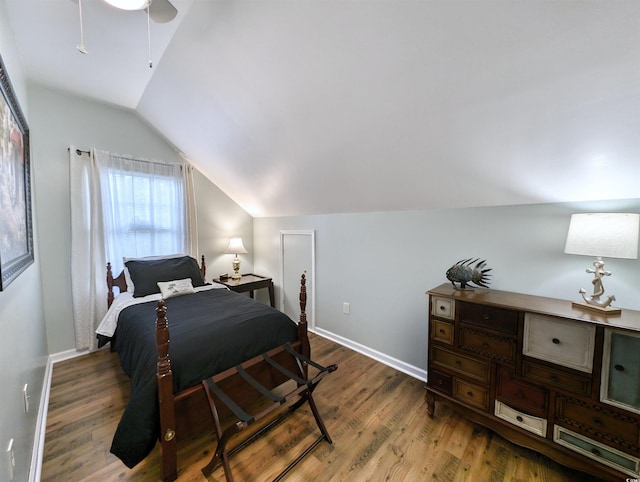 bedroom with lofted ceiling, ceiling fan, and dark hardwood / wood-style flooring