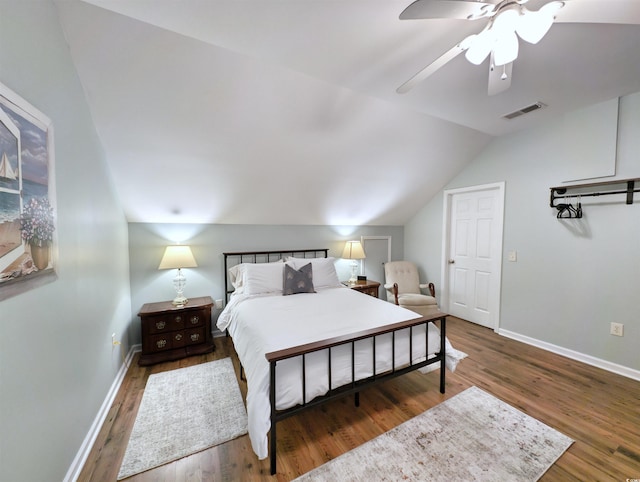 bedroom with dark wood-type flooring, ceiling fan, and vaulted ceiling