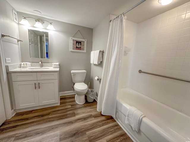 full bathroom with toilet, vanity, wood finished floors, shower / tub combo, and baseboards