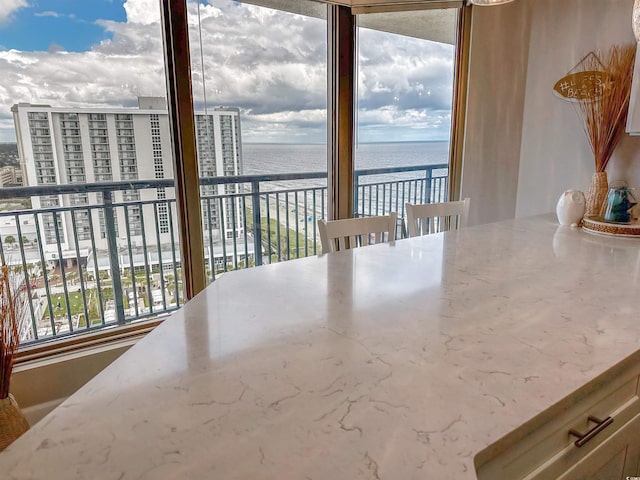 interior space featuring a water view and floor to ceiling windows