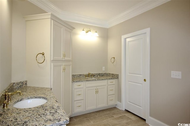 bathroom featuring tile patterned flooring, crown molding, and vanity