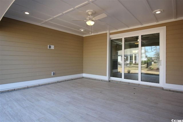 exterior space featuring ceiling fan, hardwood / wood-style floors, and wooden walls