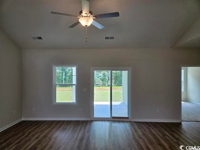 unfurnished room with vaulted ceiling, ceiling fan, and dark wood-type flooring