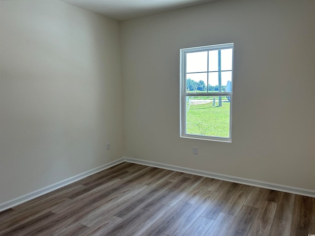 empty room with hardwood / wood-style flooring