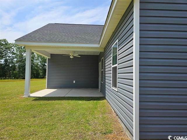 view of property exterior with ceiling fan and a lawn