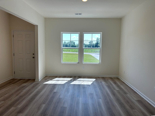 spare room with dark hardwood / wood-style flooring