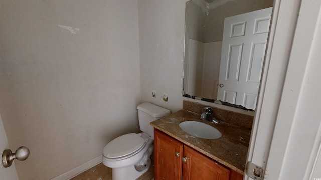 bathroom with vanity, tile patterned flooring, and toilet