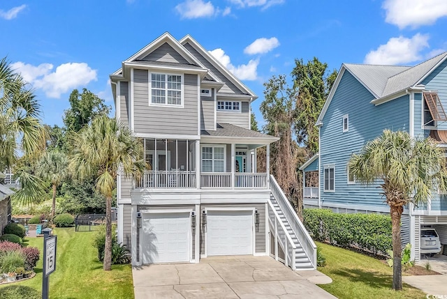 coastal inspired home with a front lawn and a garage