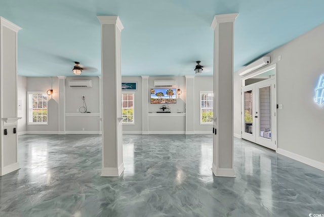 entryway featuring french doors, a wall mounted AC, concrete flooring, and a wealth of natural light