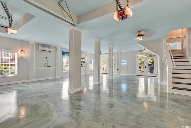 garage featuring an AC wall unit and a garage door opener