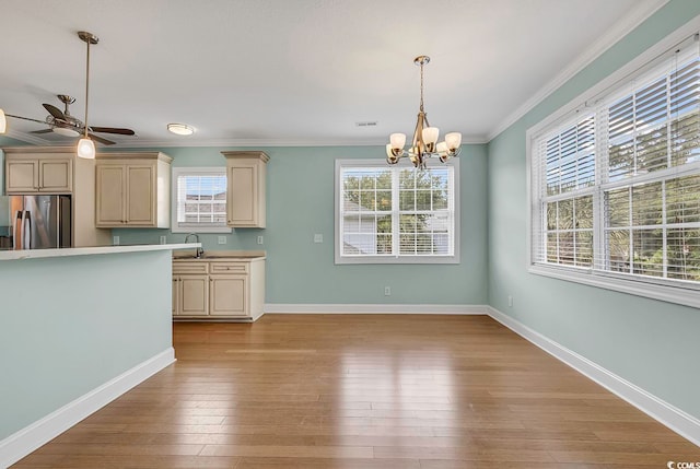 kitchen with a wealth of natural light, stainless steel fridge, and light hardwood / wood-style floors