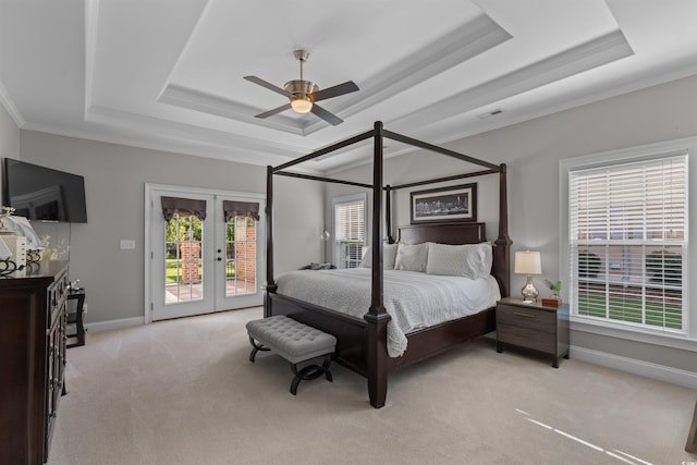 carpeted bedroom with ceiling fan, access to outside, a raised ceiling, and crown molding