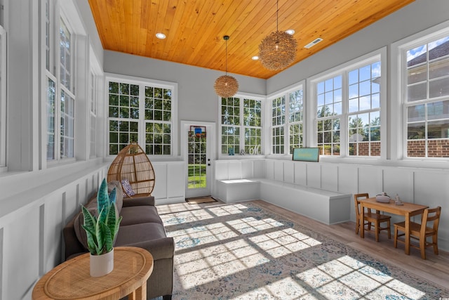 sunroom with wooden ceiling and a healthy amount of sunlight