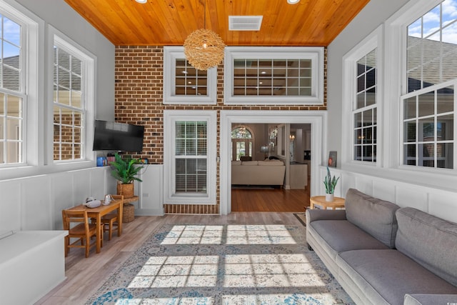 living room featuring visible vents, wooden ceiling, and wood finished floors