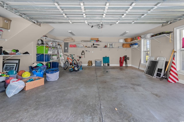 garage featuring electric panel and a garage door opener