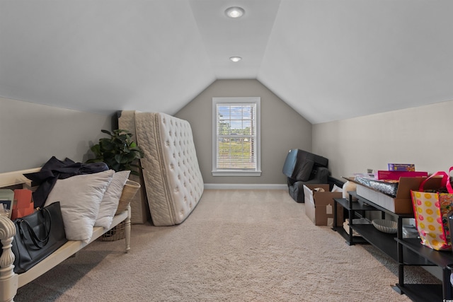 carpeted office space featuring baseboards and lofted ceiling