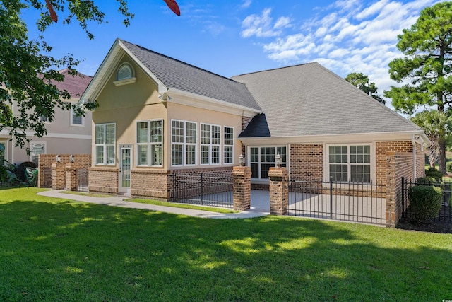 rear view of house featuring a yard