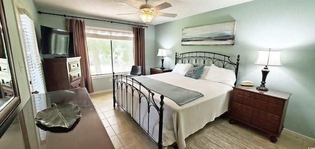 tiled bedroom with ceiling fan