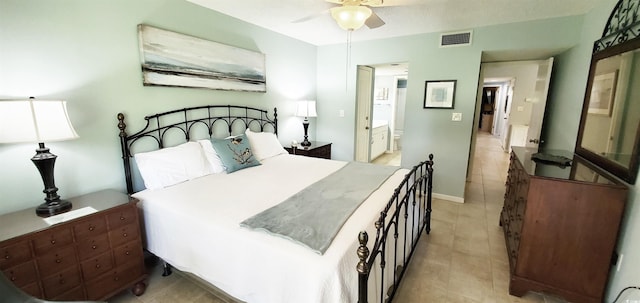 tiled bedroom featuring ceiling fan and ensuite bathroom