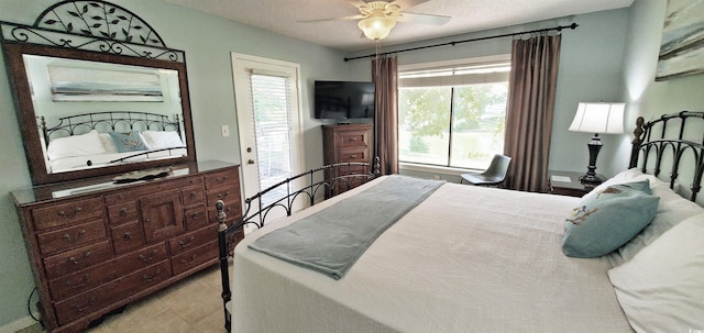 bedroom with a textured ceiling, access to outside, and ceiling fan