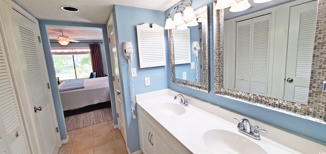 bathroom with vanity, a textured ceiling, tile patterned floors, and ceiling fan