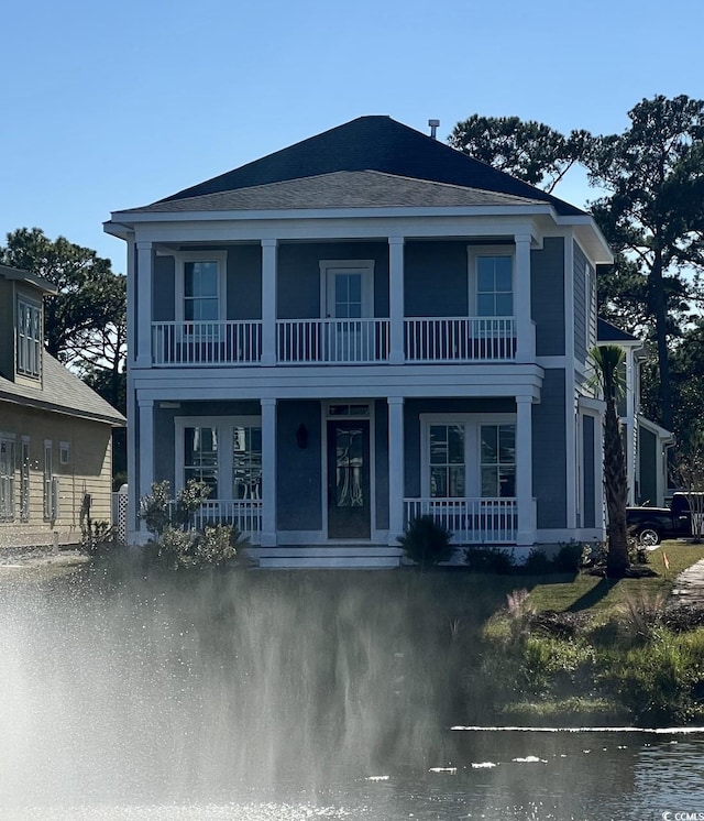 view of front facade featuring a balcony and covered porch