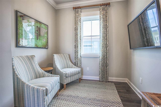 living area with crown molding and dark wood-type flooring