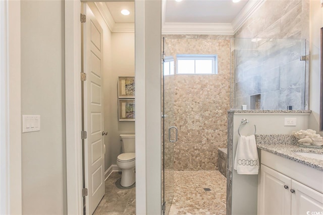 bathroom featuring crown molding, vanity, toilet, and an enclosed shower