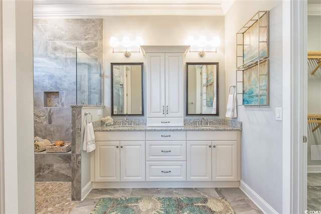 bathroom with vanity, crown molding, and tiled shower