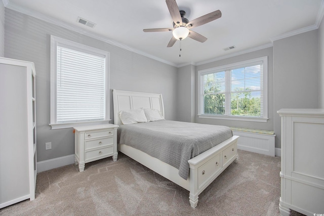 carpeted bedroom with ceiling fan and crown molding