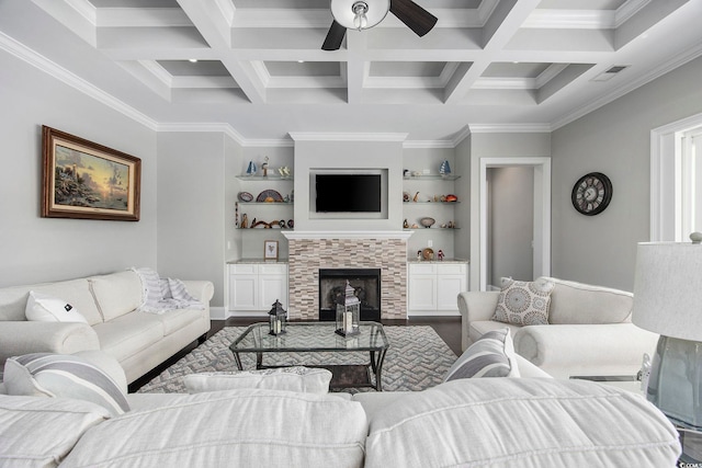 living room featuring crown molding, coffered ceiling, and a tile fireplace