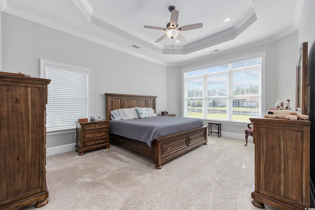 bedroom with crown molding, a raised ceiling, and light colored carpet