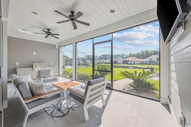 sunroom / solarium featuring ceiling fan