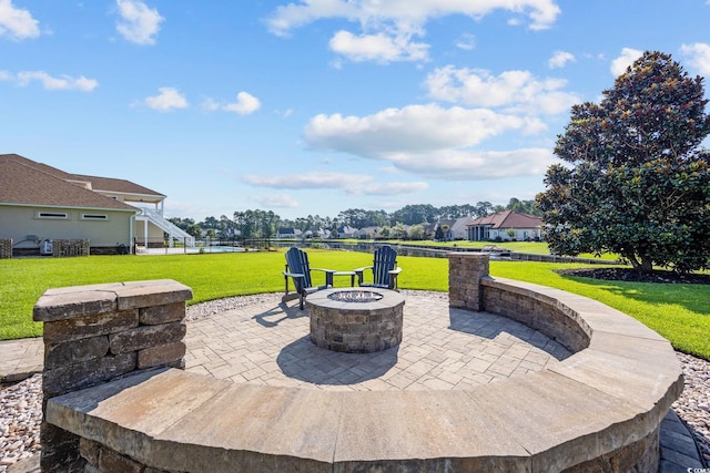 view of patio / terrace featuring a water view and an outdoor fire pit