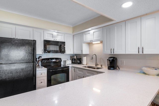 kitchen featuring sink, white cabinetry, decorative backsplash, black appliances, and ornamental molding