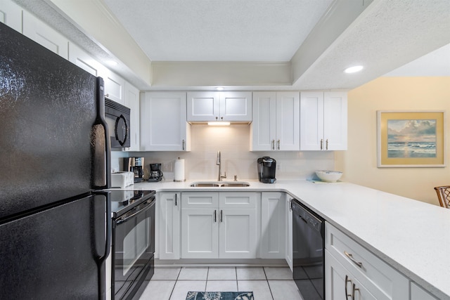 kitchen featuring light tile patterned floors, sink, backsplash, white cabinetry, and black appliances