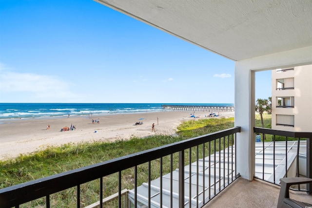 balcony with a view of the beach and a water view