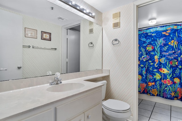 bathroom with curtained shower, tile patterned flooring, vanity, and toilet