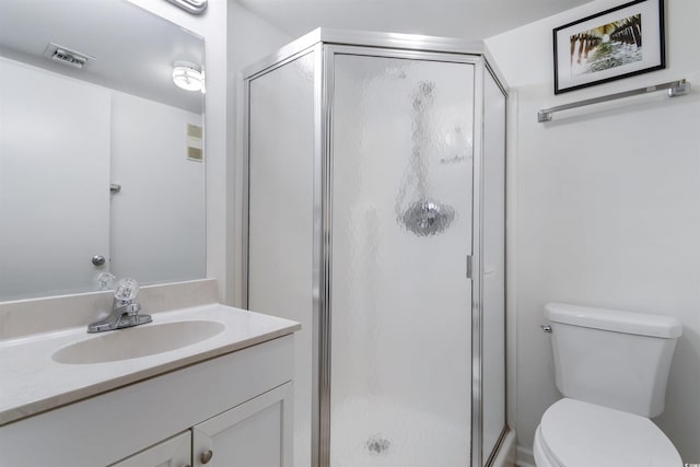 bathroom featuring vanity, toilet, and an enclosed shower