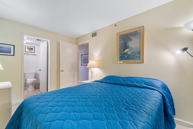 carpeted bedroom featuring ensuite bath