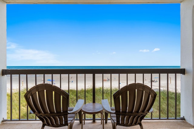 balcony with a view of the beach and a water view