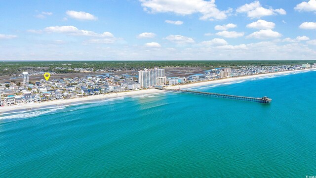 birds eye view of property featuring a water view and a beach view