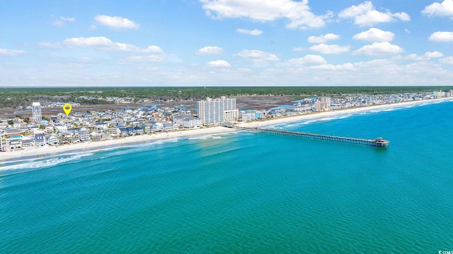 aerial view featuring a water view, a view of city, and a beach view