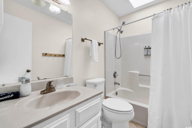 full bathroom with toilet, shower / tub combo, a skylight, vanity, and tile patterned floors