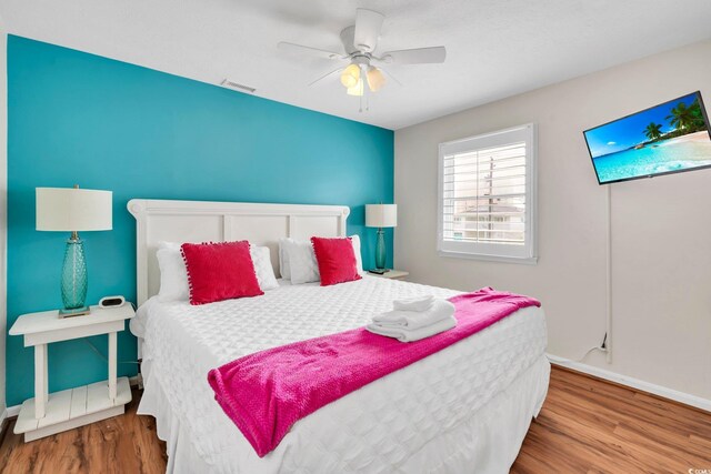 bedroom featuring ceiling fan and hardwood / wood-style flooring