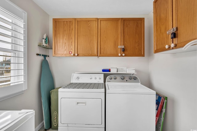 laundry room with cabinet space and washer and clothes dryer