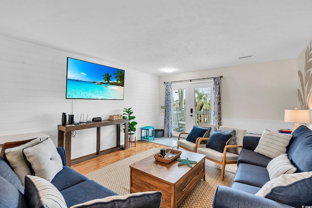 living area featuring french doors and wood finished floors