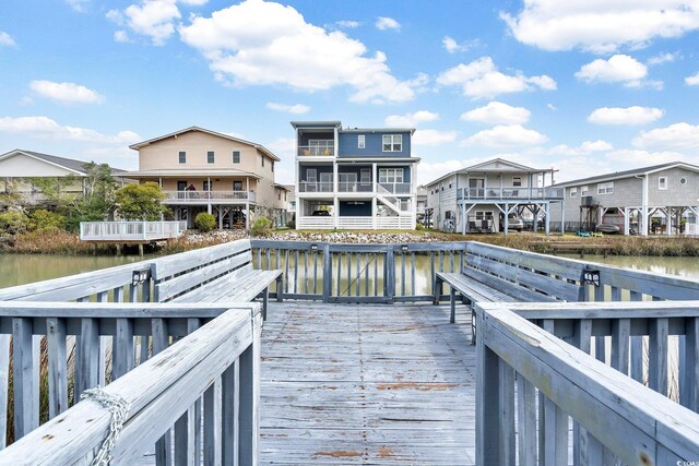 dock area featuring a deck with water view