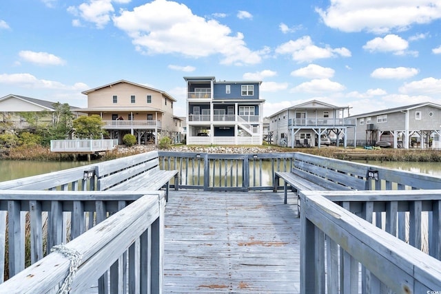 back of property with a water view and a residential view