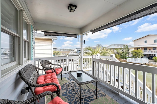 balcony with a residential view and a sunroom